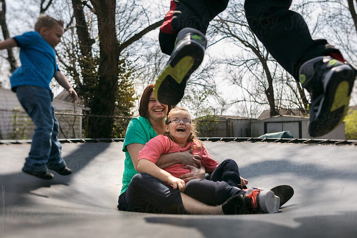 Mother Holds Paralyzed Girl On Trampoline While Friends Jump