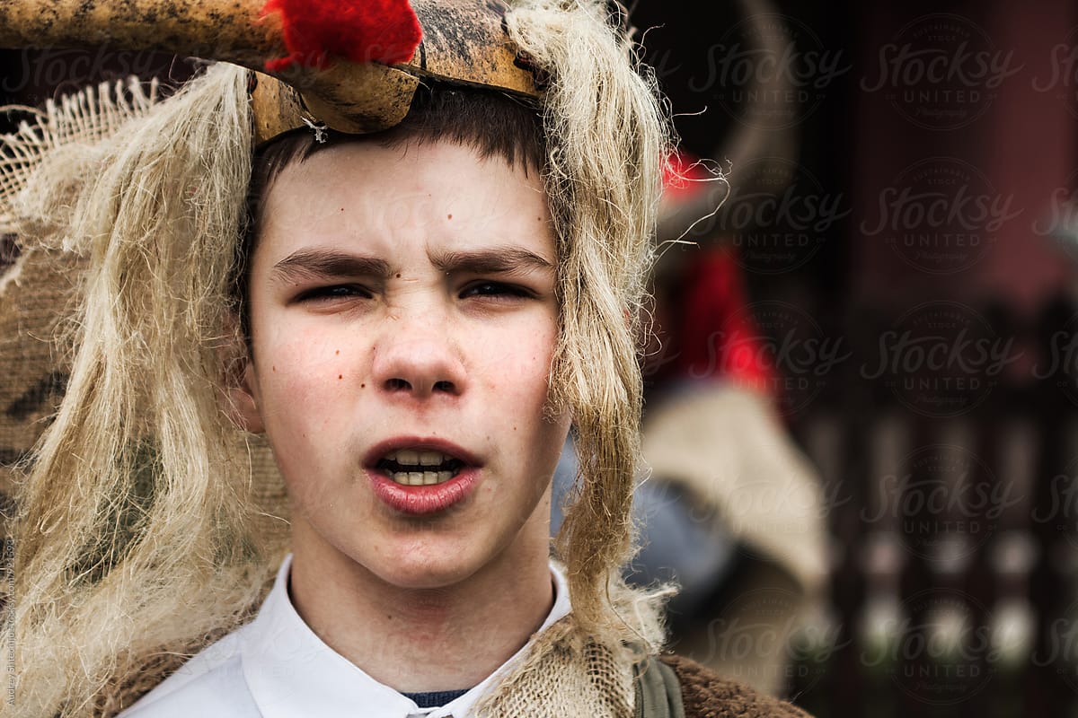 Portrait of young boy in old Slavic dress with traditional mask/Central Serbia