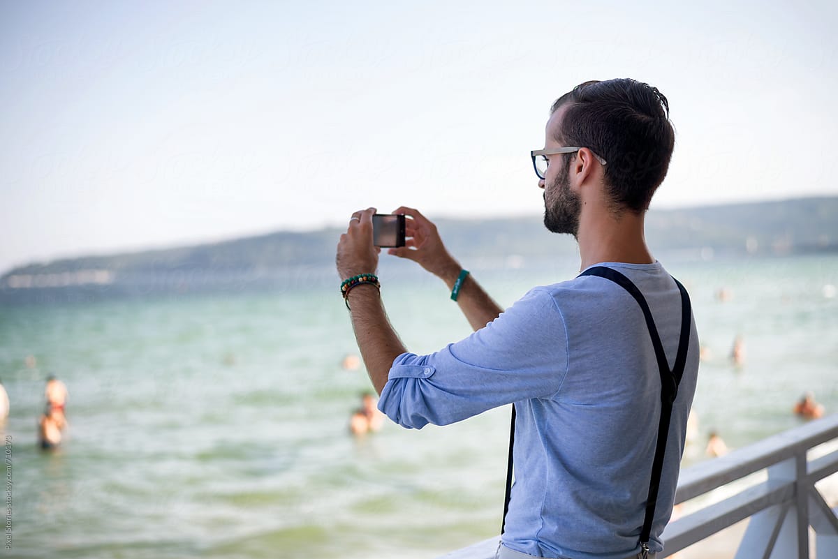 Young Man Taking Photo With His Smartphone By Stocksy Contributor Pixel Stories Stocksy 