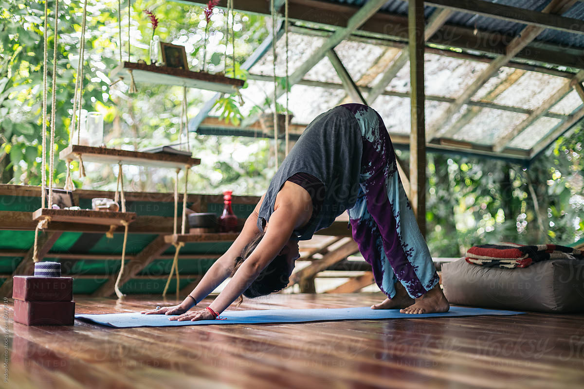 Woman Doing Yoga Inside Of A Yoga Deck