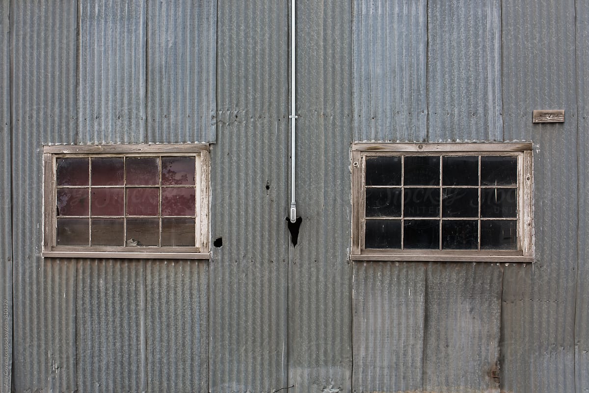 corrugated metal building with two windows
