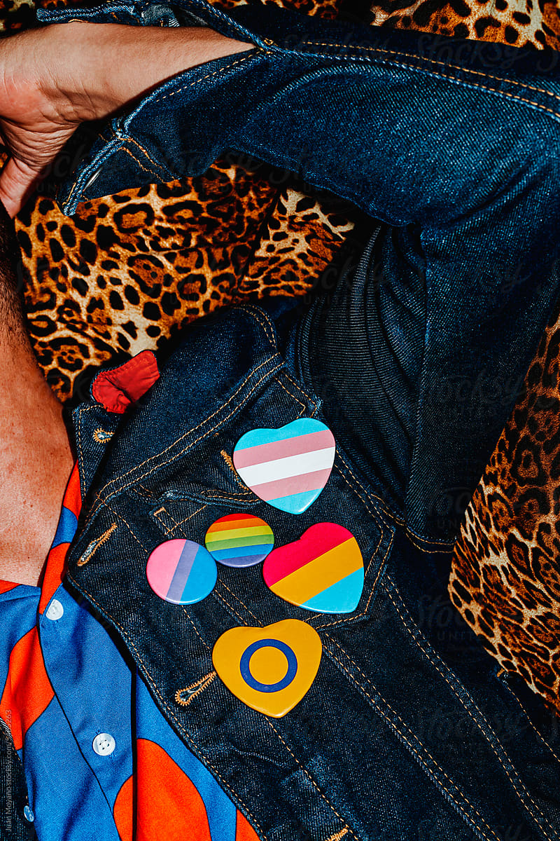 man wears some LGBTIQ pin-back buttons