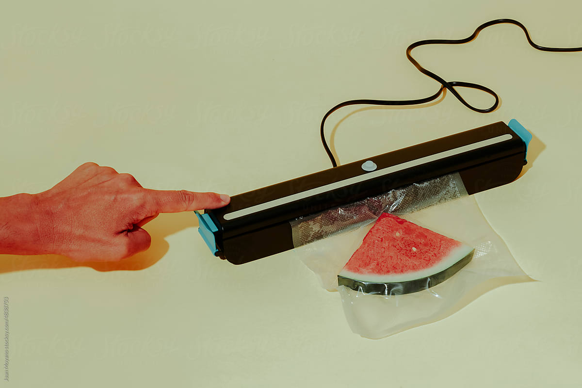 man vacuum packing a slice of watermelon