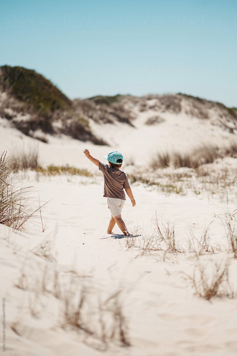 Child walk on sand.