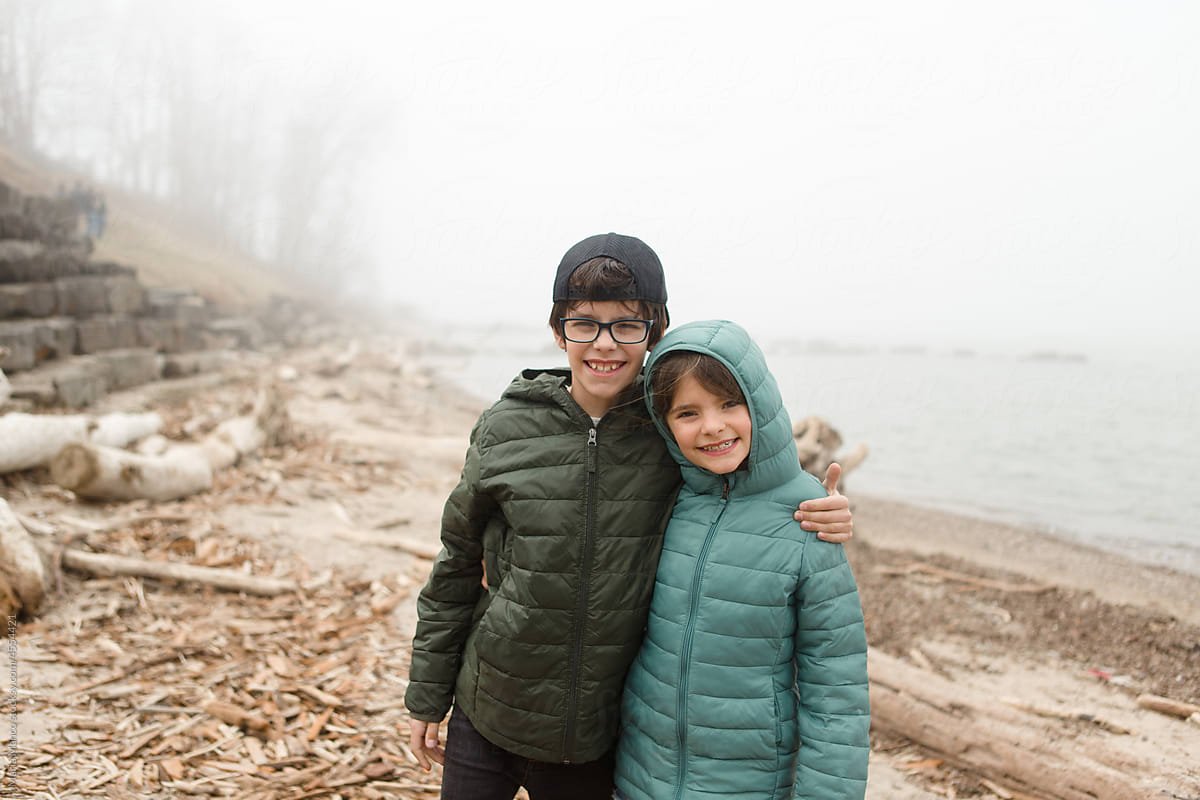 portrait of kids smiling on foggy beach