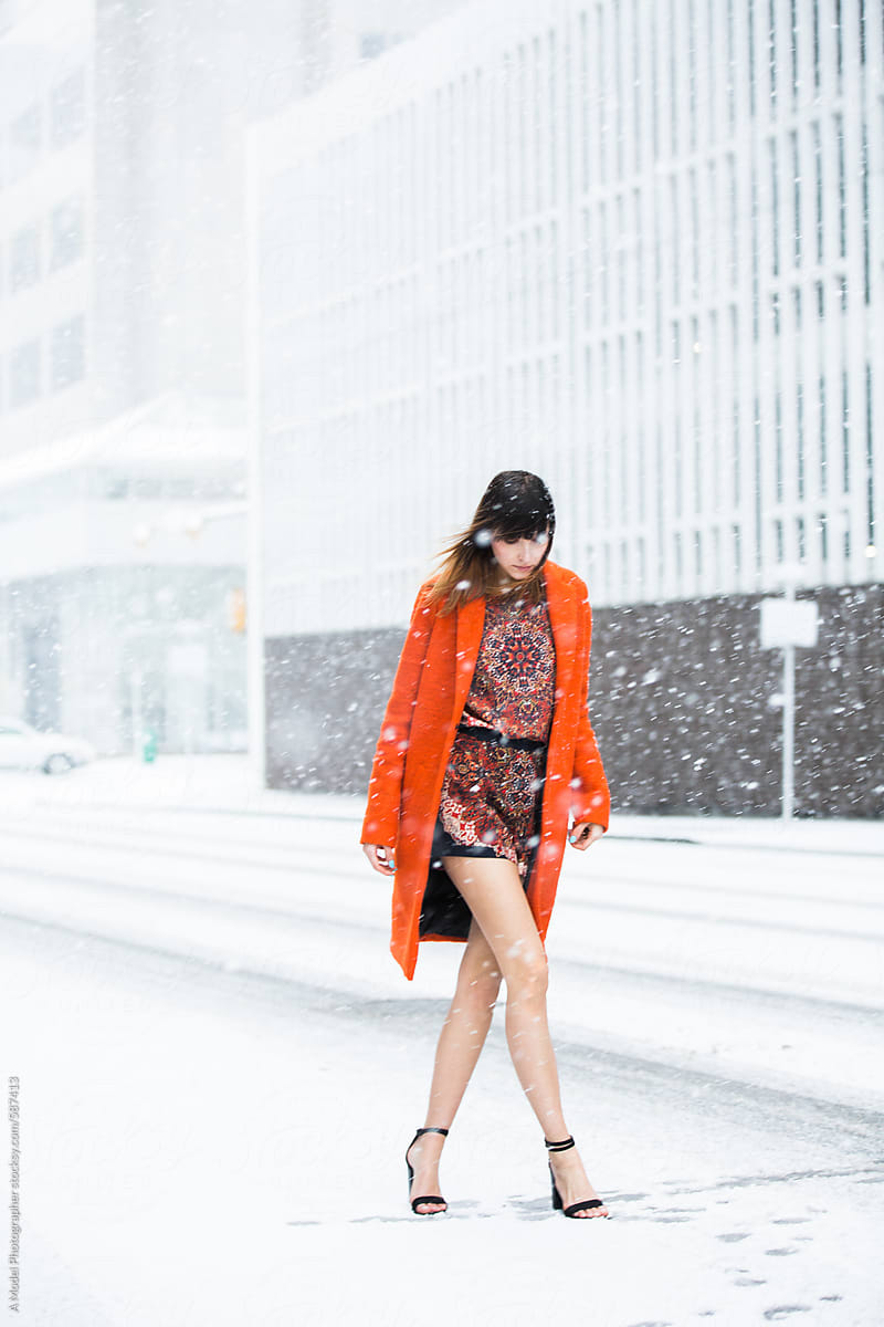 Bright orange jacket in the falling snow