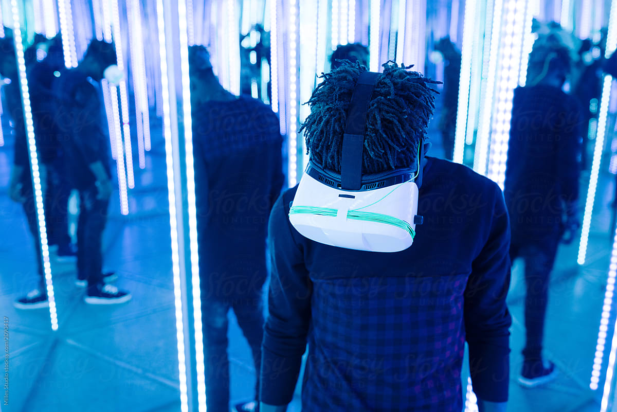 Black man in VR glasses in neon lights