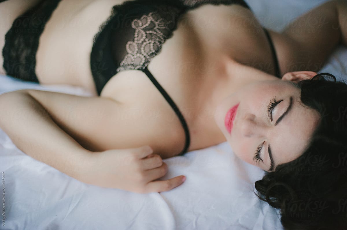 Woman In Black Lace Bra Lying On Bed by Stocksy Contributor Jess Craven  - Stocksy