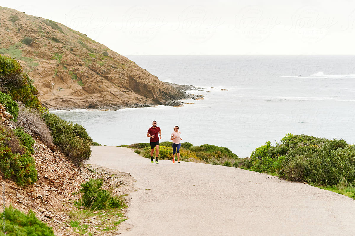 Couple out for a run by the coast
