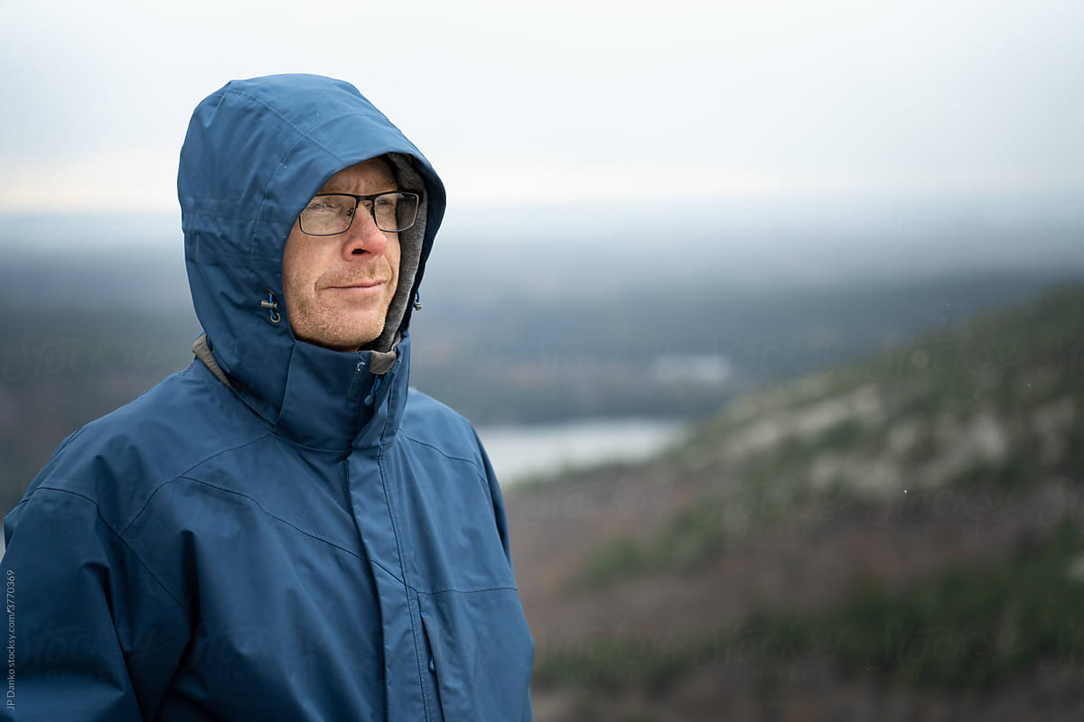 Portrait of Man at Cold Mountain Lookout with Forest and Snow