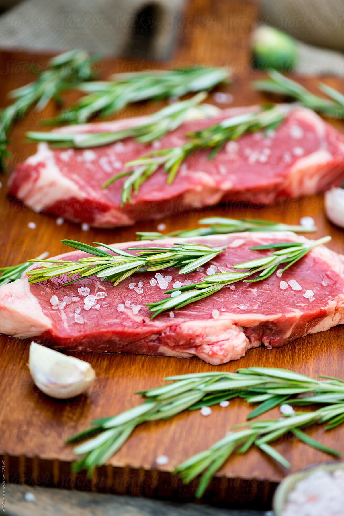 Two Raw Sirloin Steaks with Rosemary