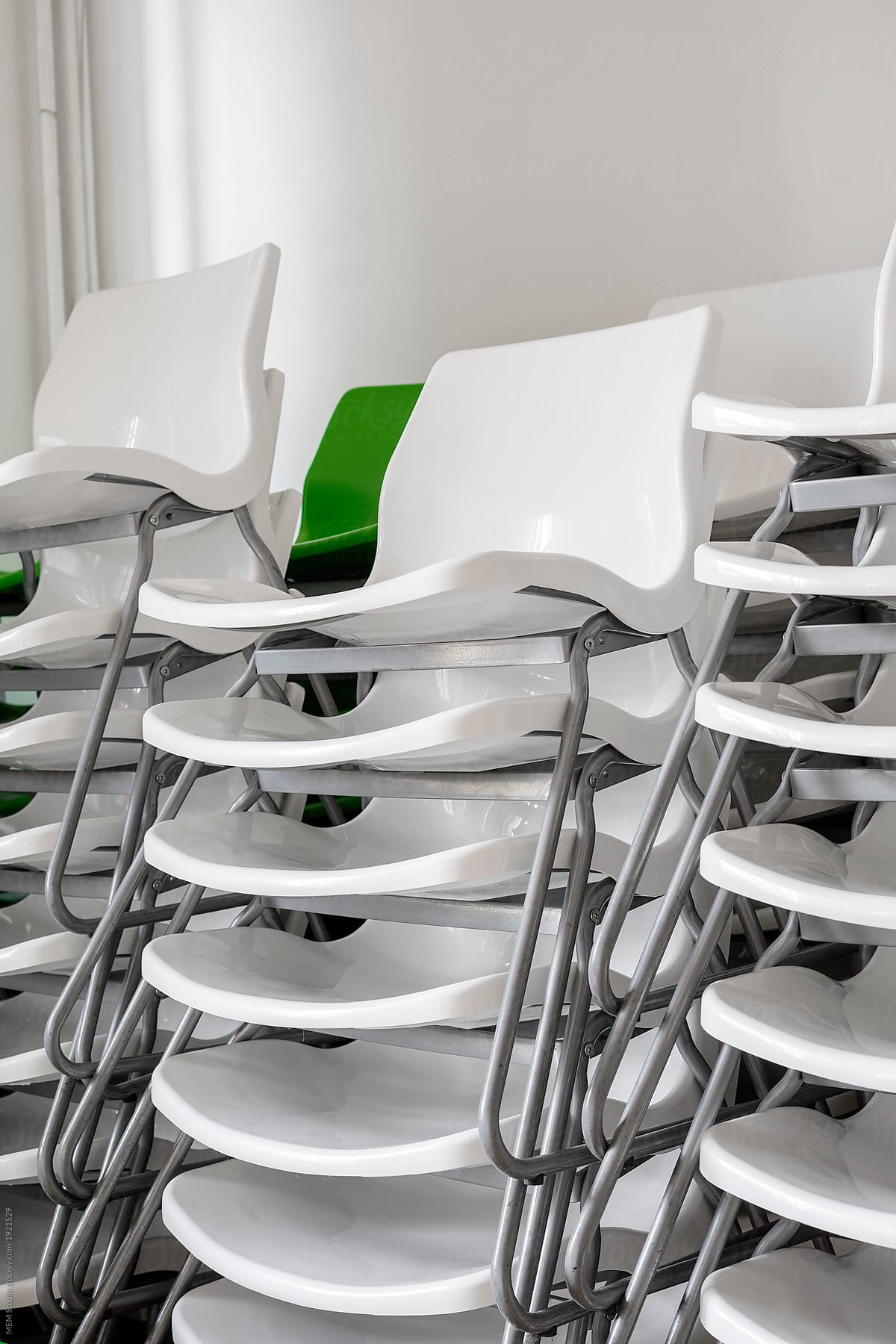 A stack of contemporary chairs waiting for an event to be used