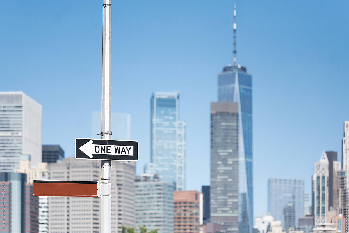 Manhattan skyline behind one way street sign