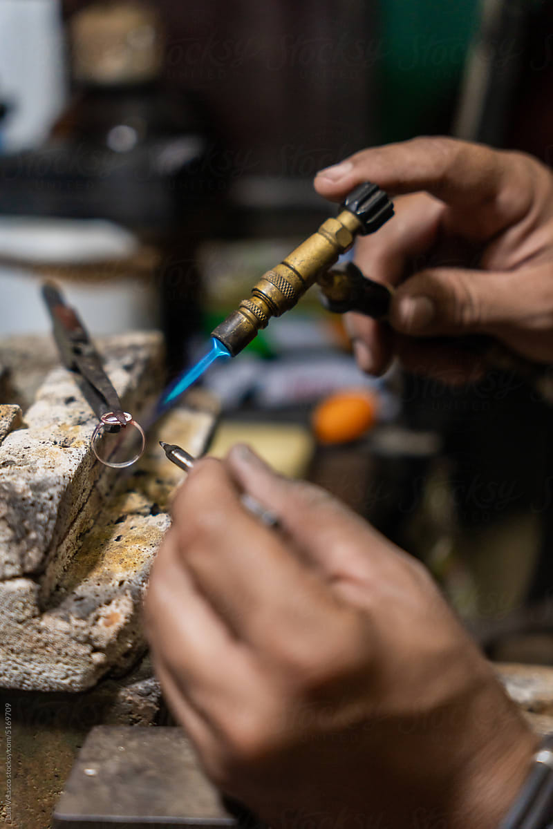 Close Up Of Anonymous Jeweler Soldering A Ring