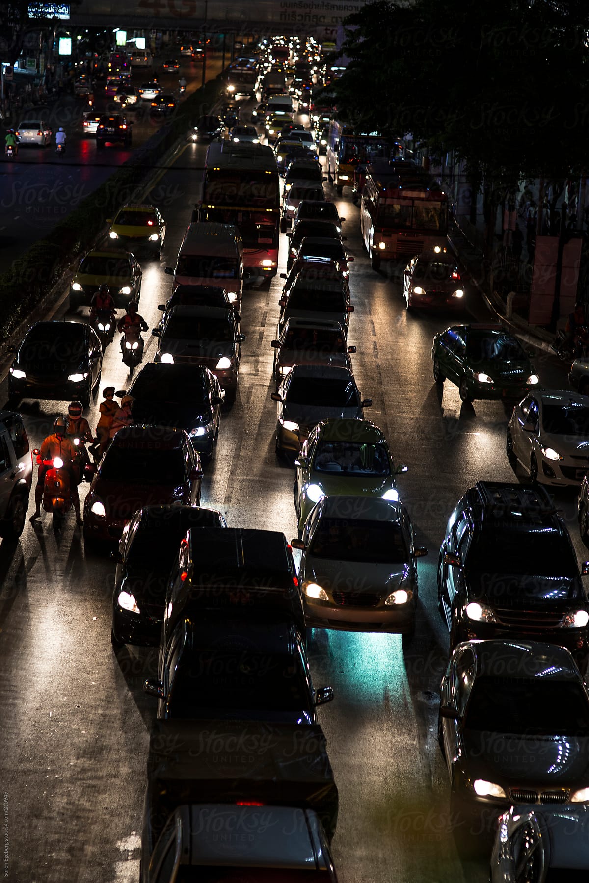 Big city traffic jam with cars and motorbikes at night in Bangkok, Thailand