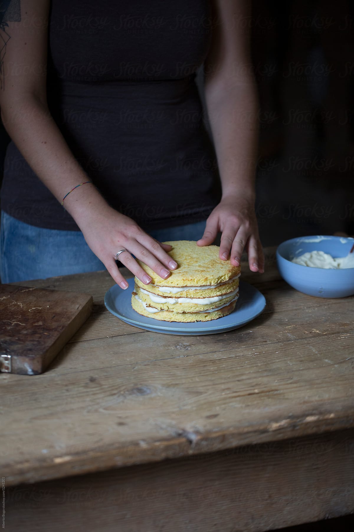 Crop hands making cake