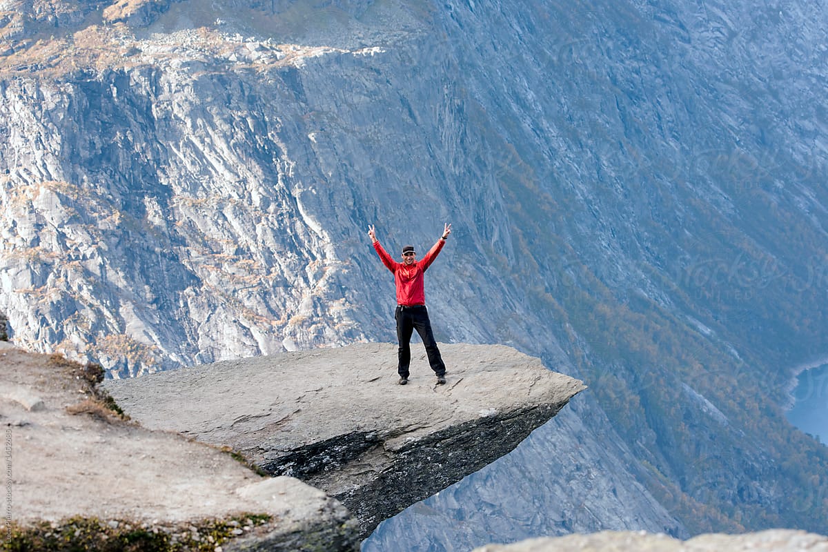 Happy Hiker on the Trolltunga rock, Norway