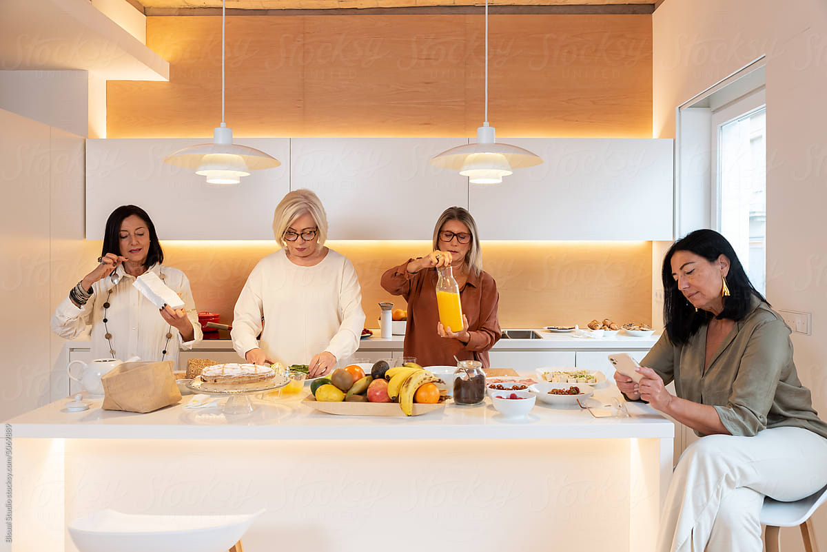 Female friends in sunlit kitchen