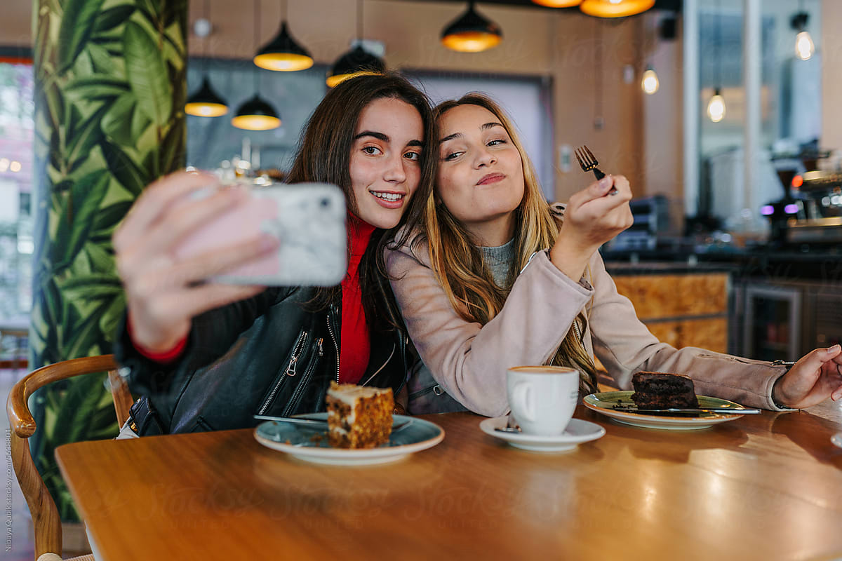 Best friends taking a selfie at a coffee shop