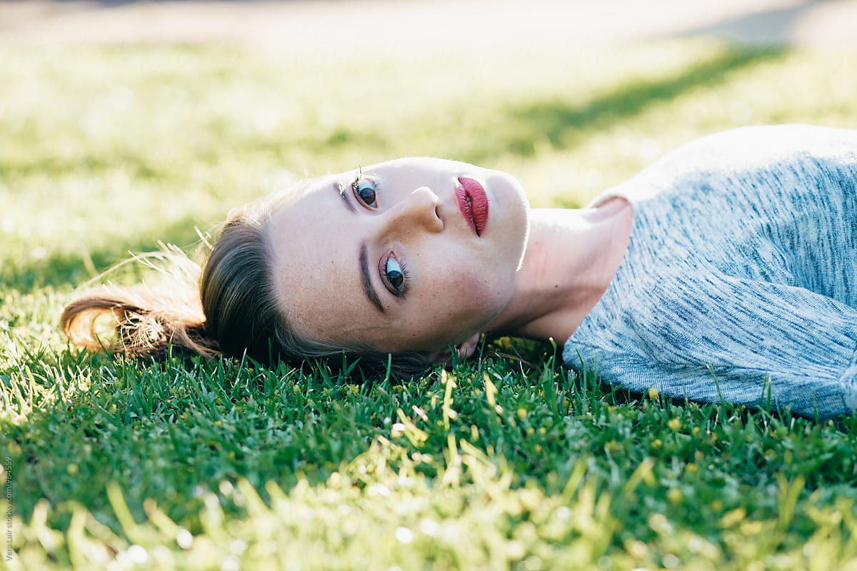 Young Woman Laying On The Gra By Stocksy Contributor Vera Lair