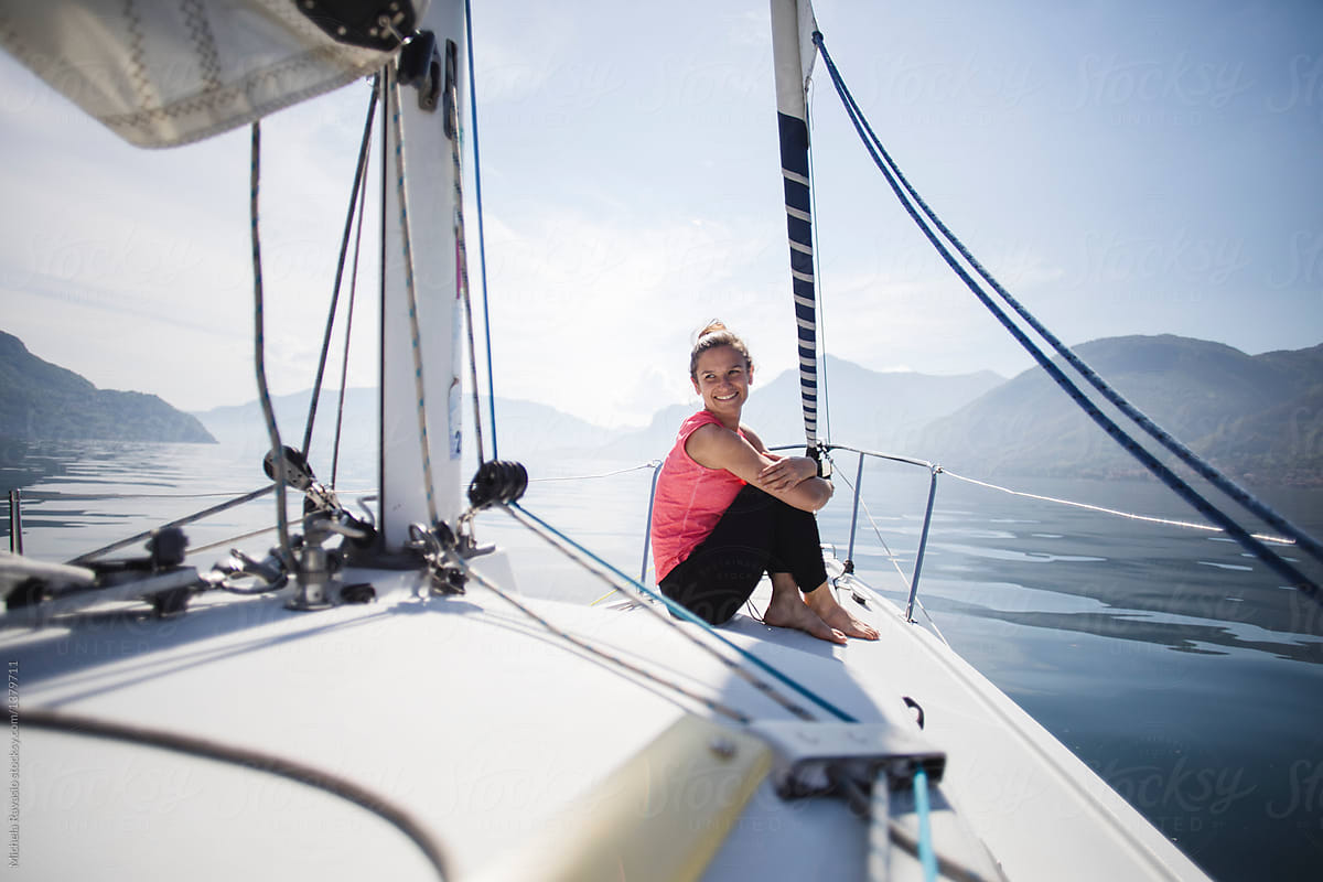 Smiling woman sitting on a sail boat