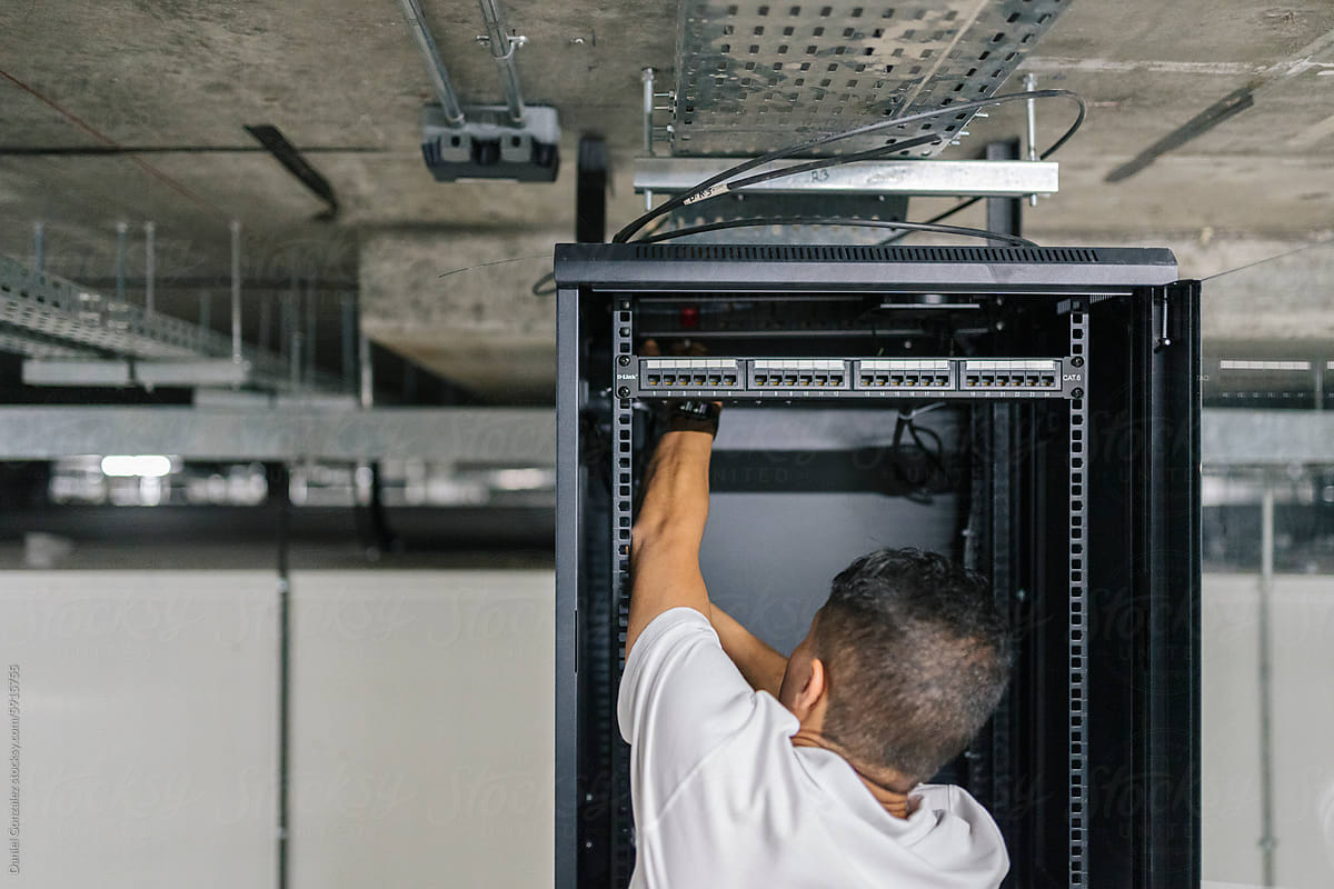 Male IT engineer installing server at workplace