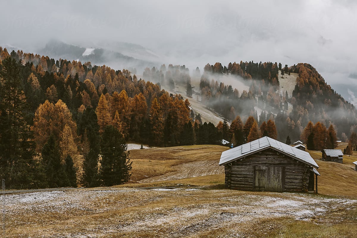 wooden mountain barns in autumnal alpine landscape - dolomites