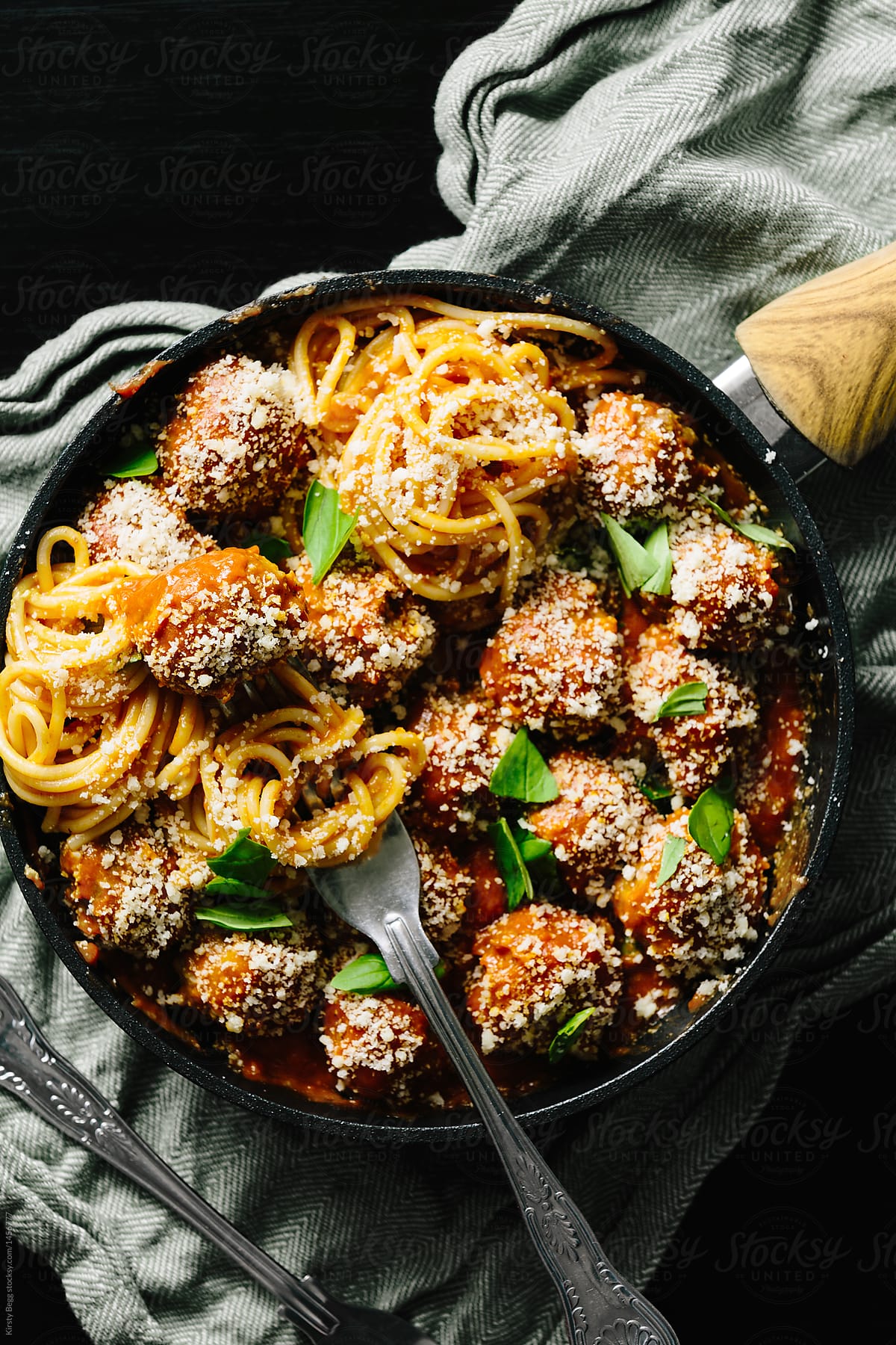 Close up of pan of meatballs and spaghetti with fork