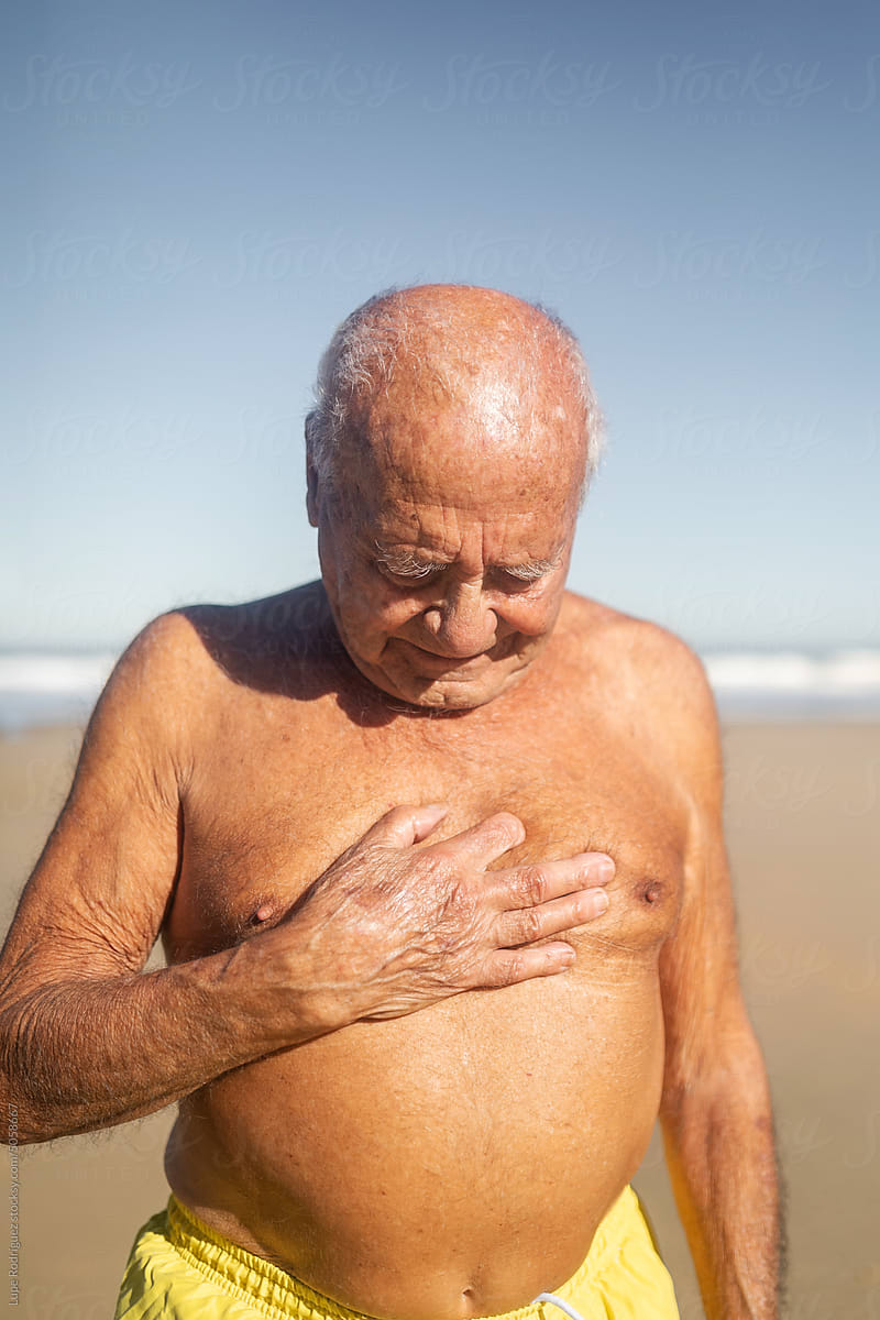 senior man in swimming trunks on the beach