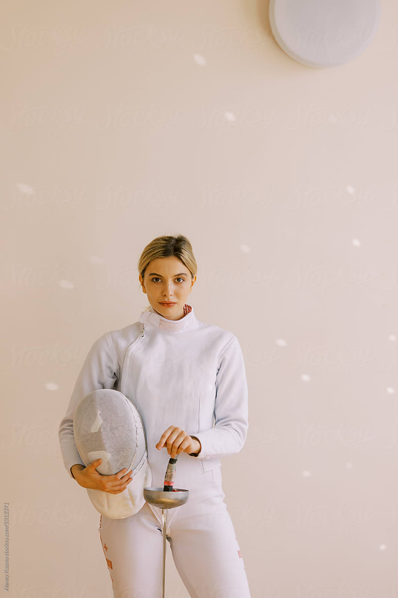 portrait of young woman with fencing uniform