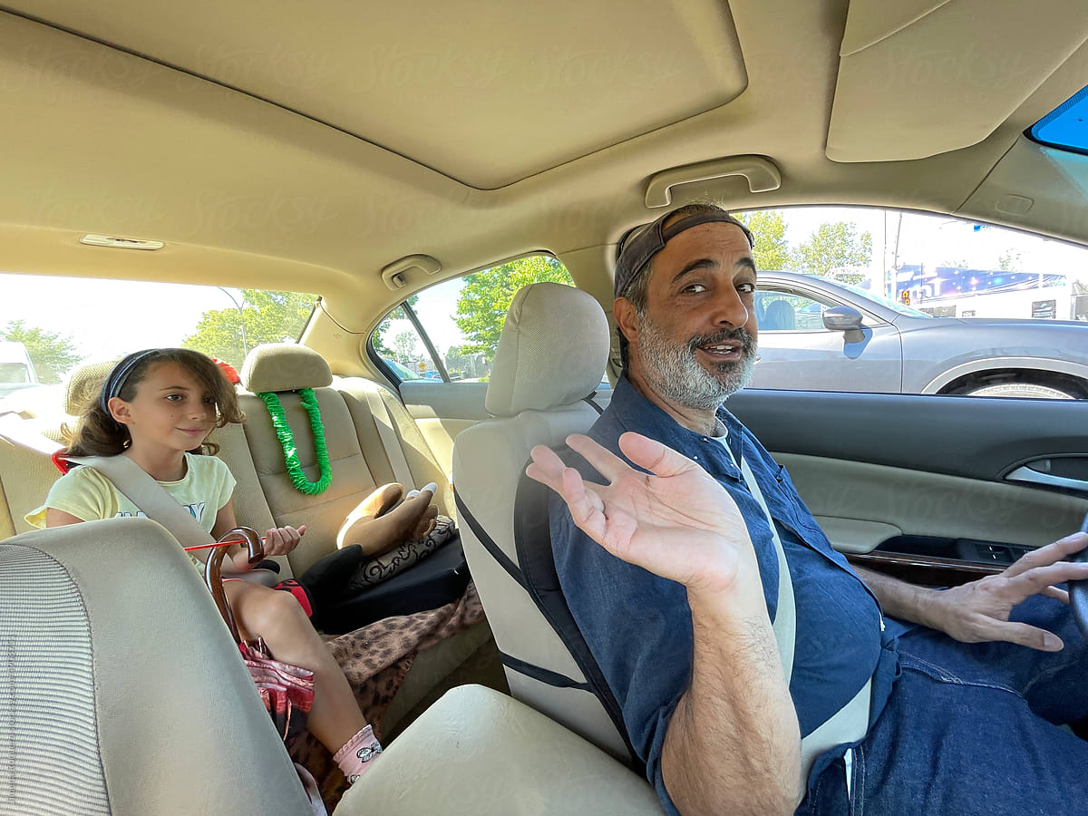 UGC mobile photo of man and kid inside a car looking at camera
