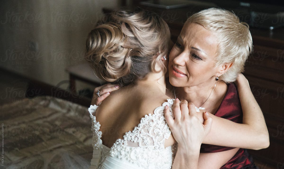 Mother and loving bride hugging in morning