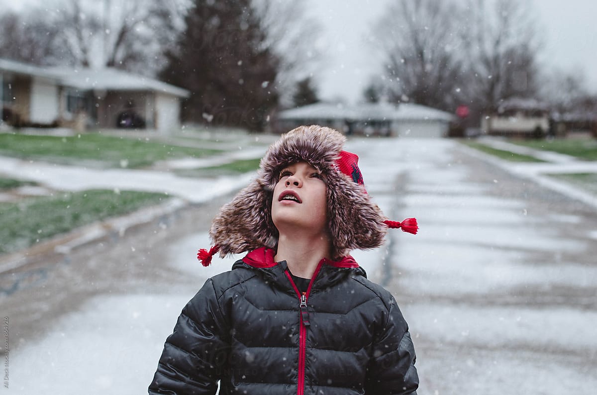 Boy Watches the Snow Fall