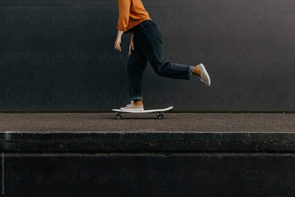 Young woman riding skateboard