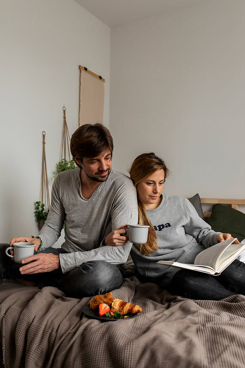couple in bed reading book together