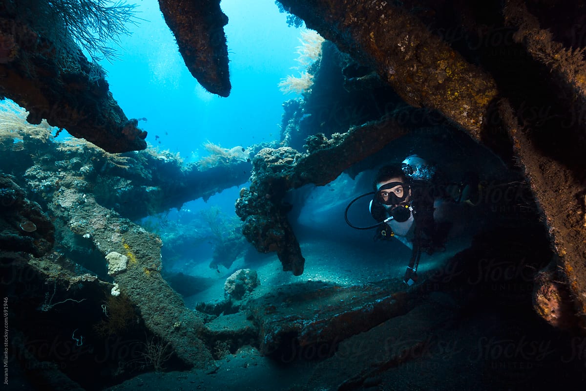 Scuba Diver swimming trough Liberty Shipwreck in Tulamben, Bali