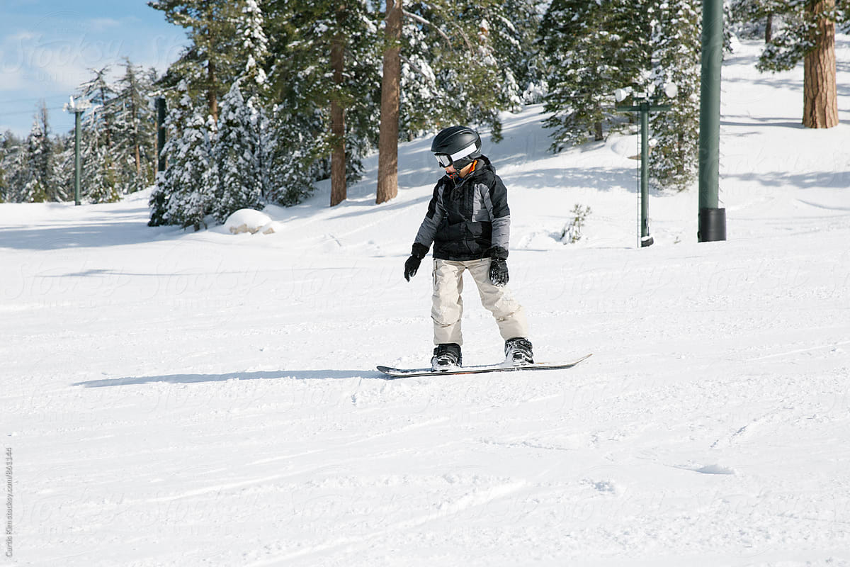 Kid having fun riding his snowboard