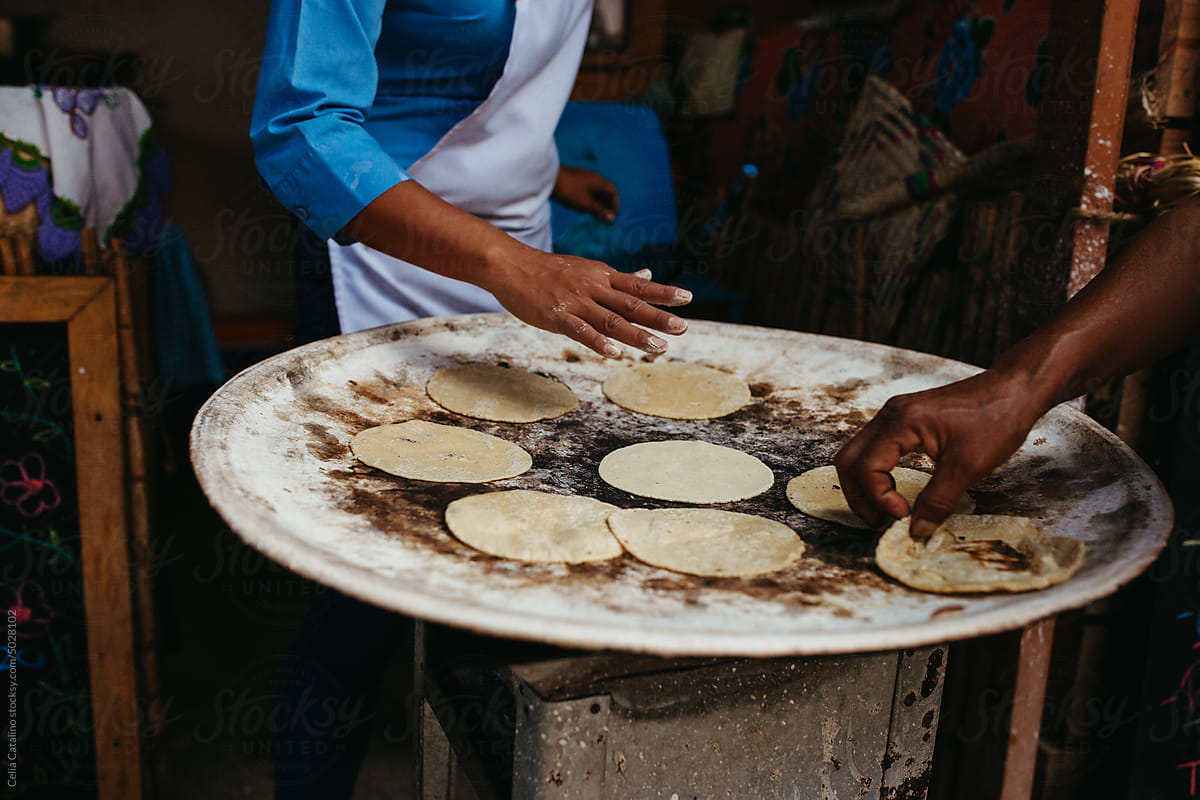 Tortillas On A Comal by Stocksy Contributor Celia Catalino - Stocksy