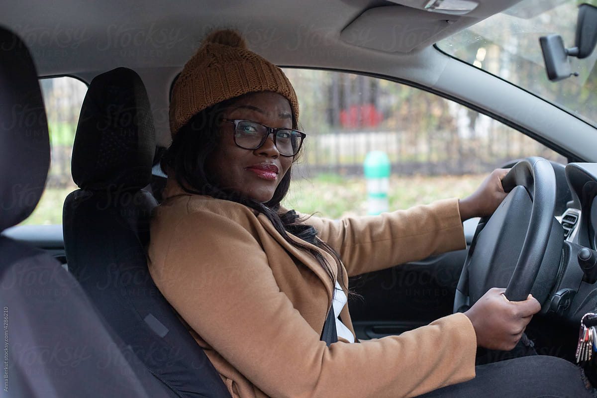 taxi driver, portrait of black woman driving a car
