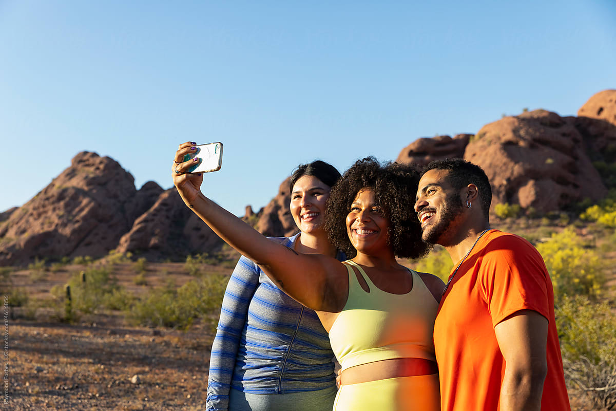 Friends Hiking together in Arizona taking mobile phone selfie