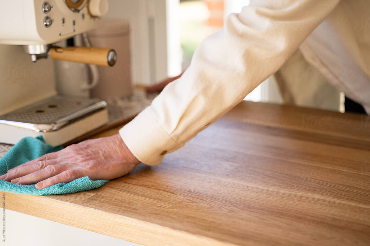 Close-up Senior man cleaning up kitchen counter top