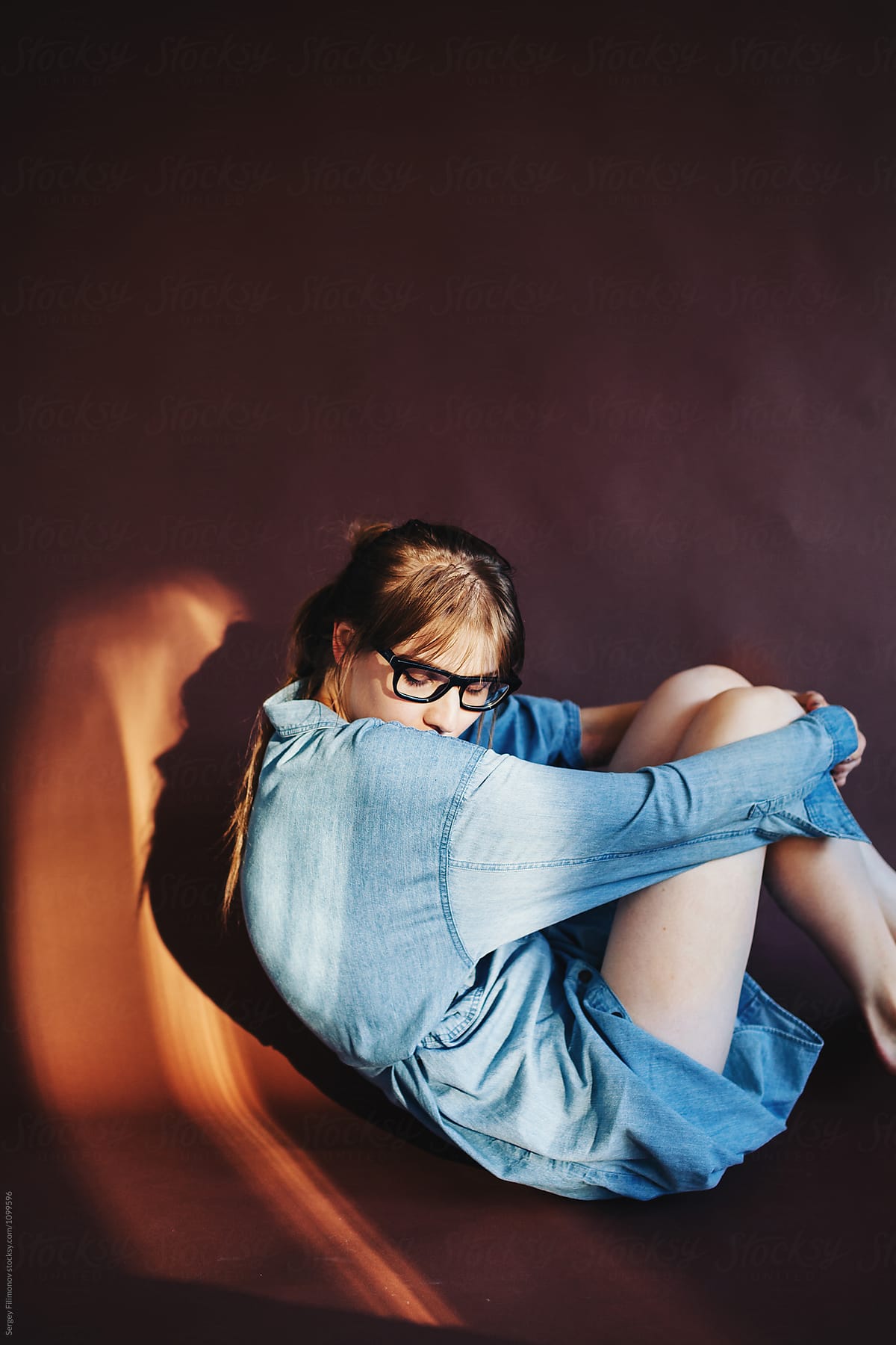 Woman Embracing Knees Posing In Studio By Stocksy Contributor Sergey