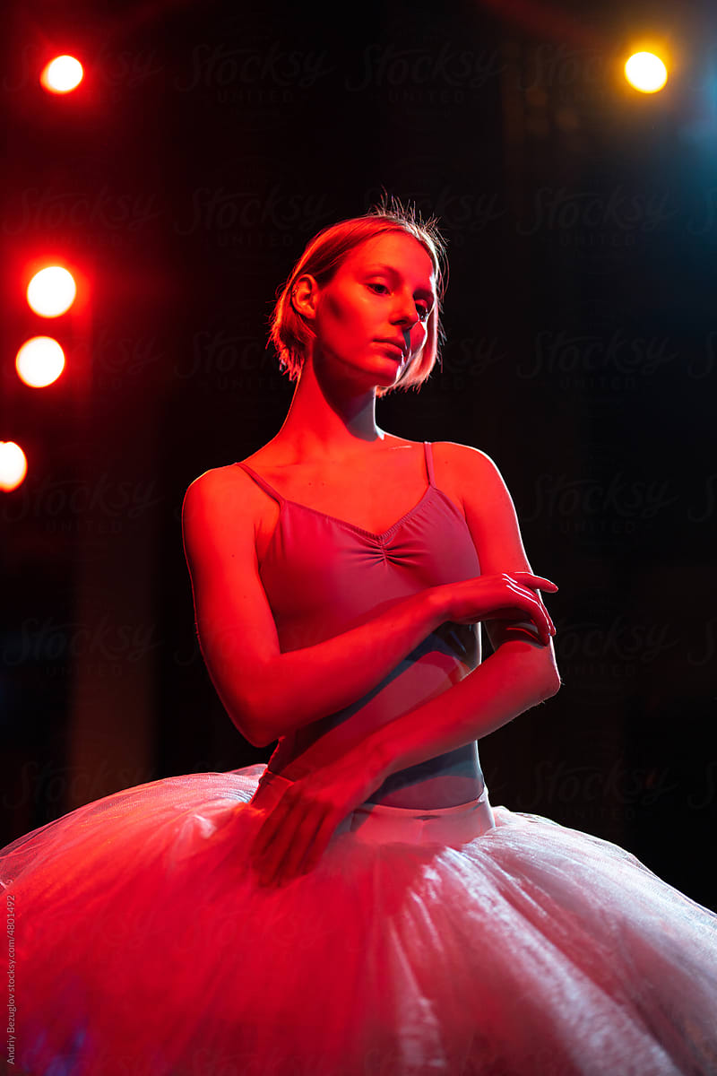 Neon light shot of the ballerina posing in ballet costume