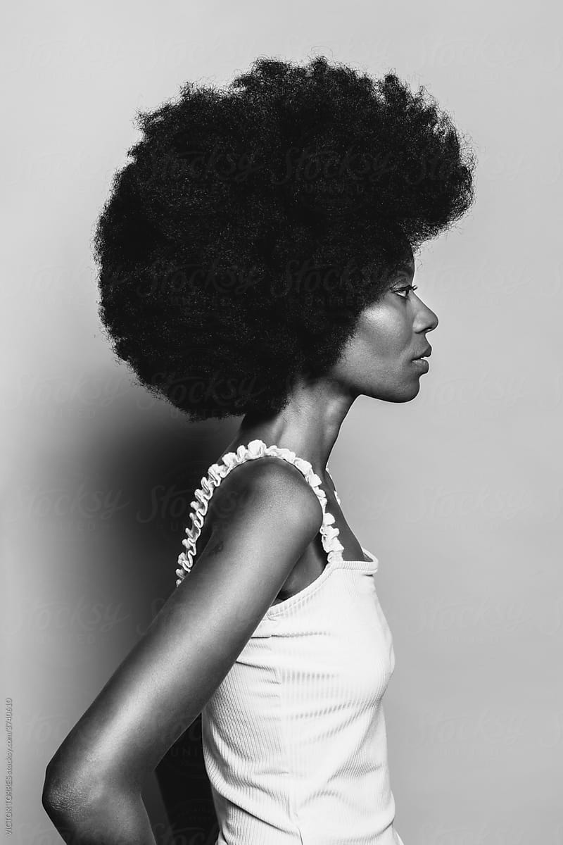 Side view of beautiful Afro Woman posing over white background