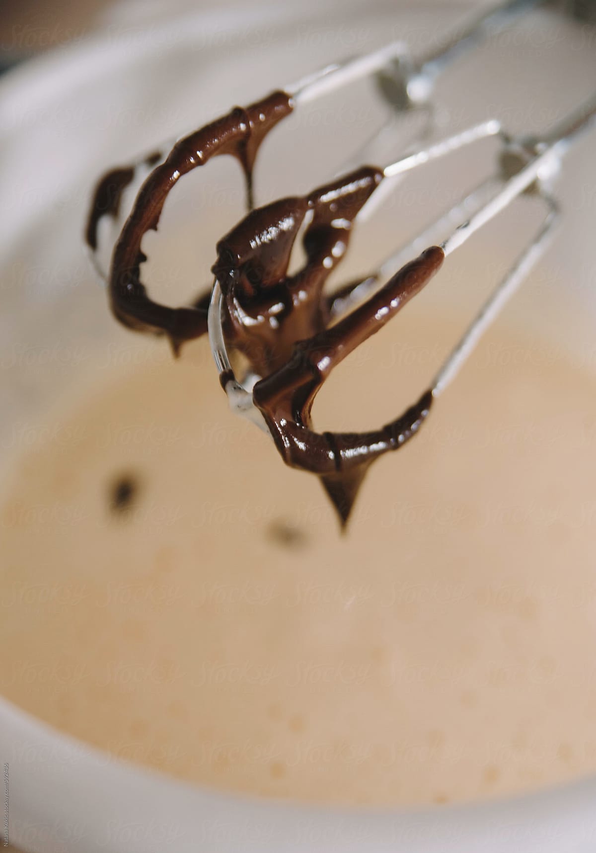 Melted chocolate peaks on a food mixer whisks