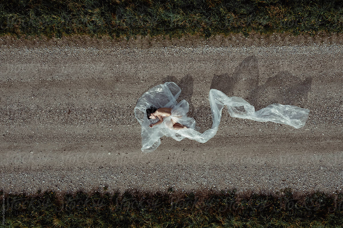 Aerial view of a woman covered with plastic