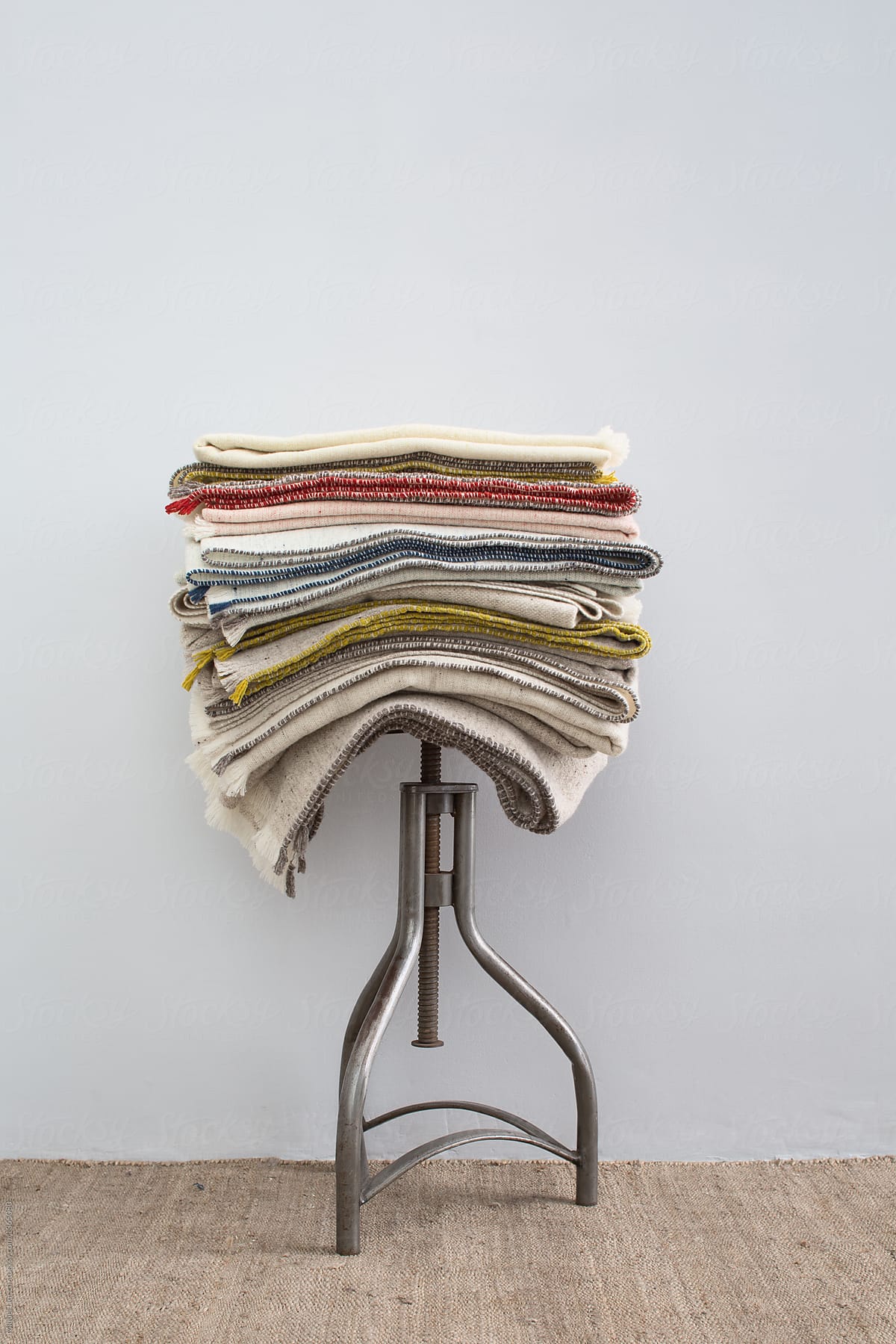 Wool blankets stack on vintage stool
