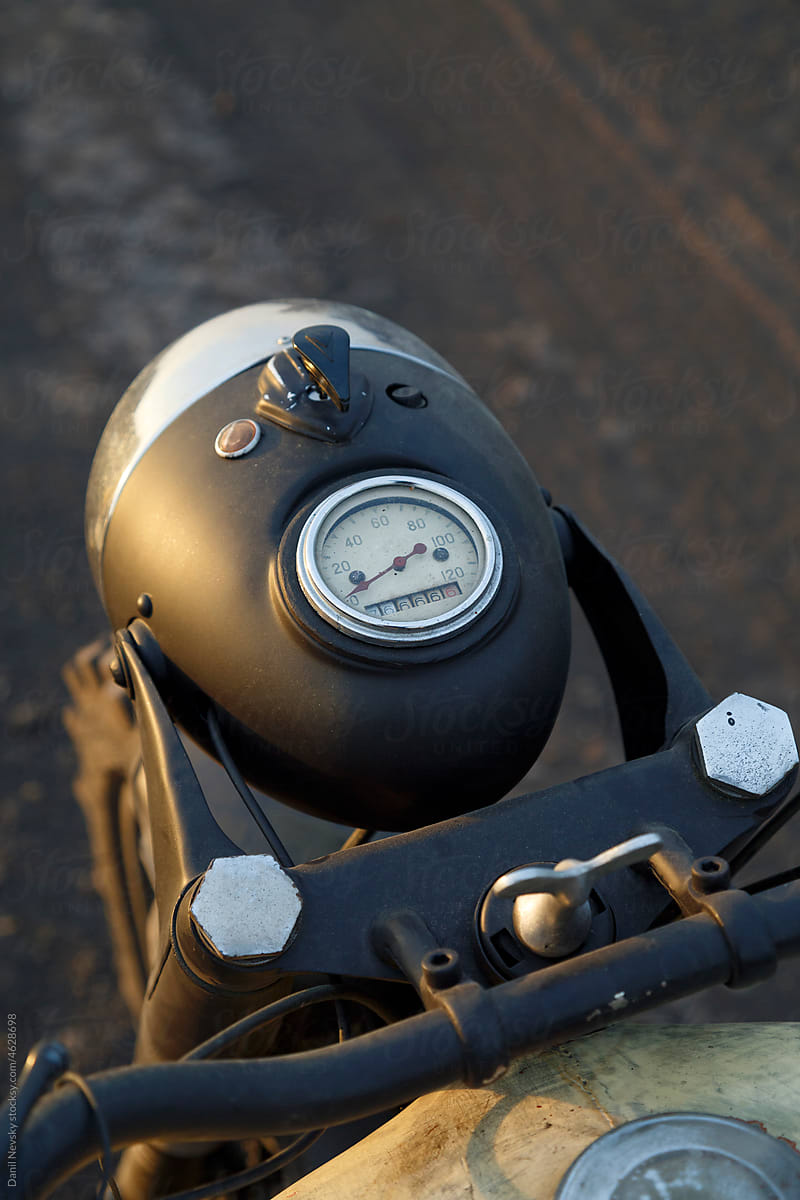 Retro motorcycle with speedometer during road trip