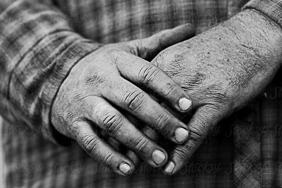 A Man\'s hands after working on a car.