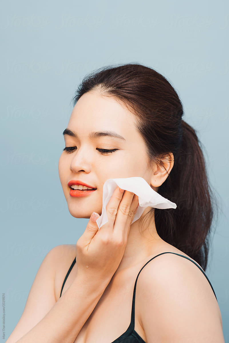 Asian Woman Removing Makeup With Wipes